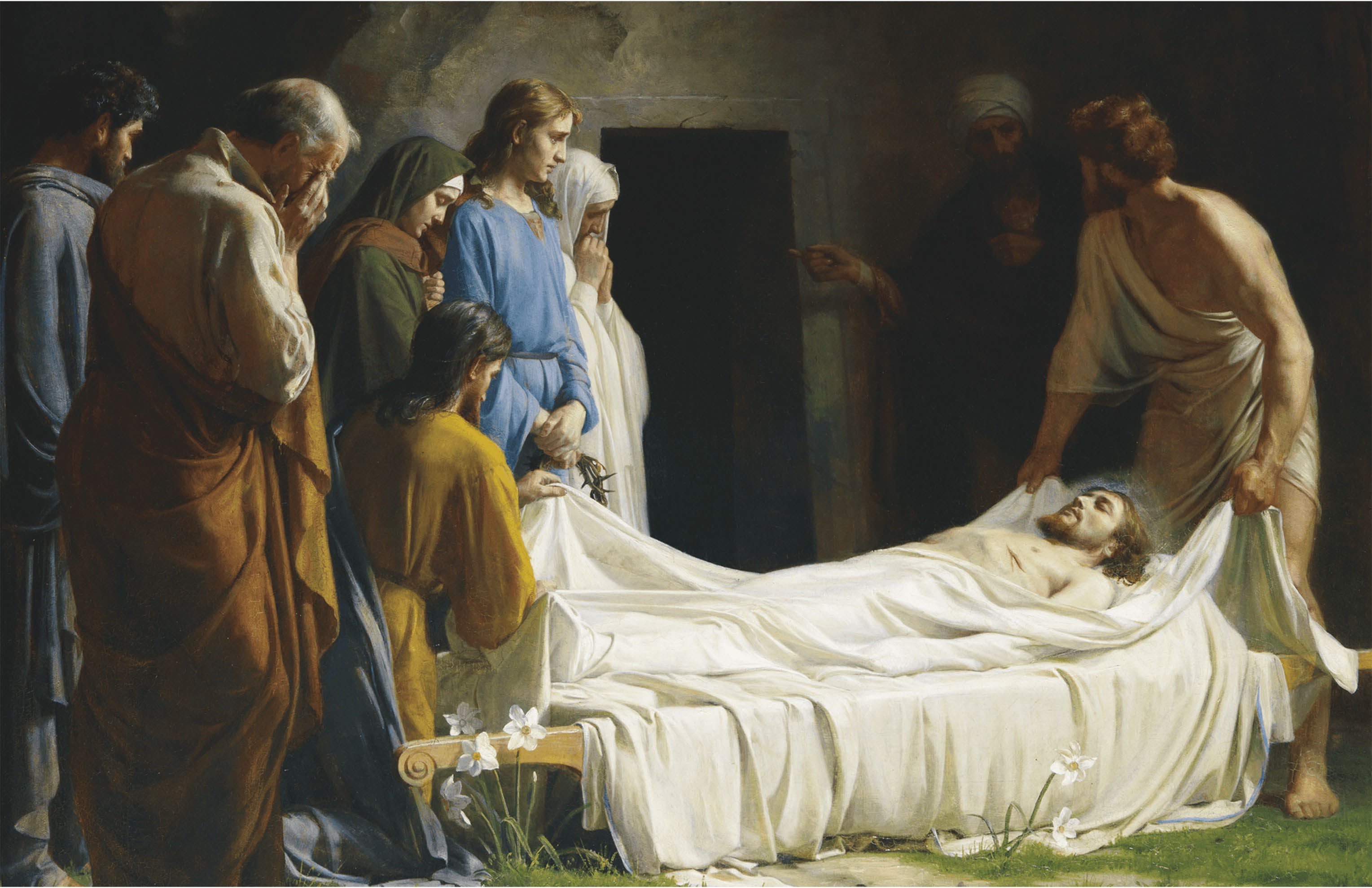 The body of Jesus being prepared for burial and laid in the tomb